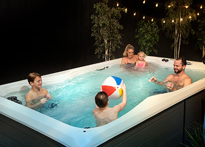family playing in a swim spa